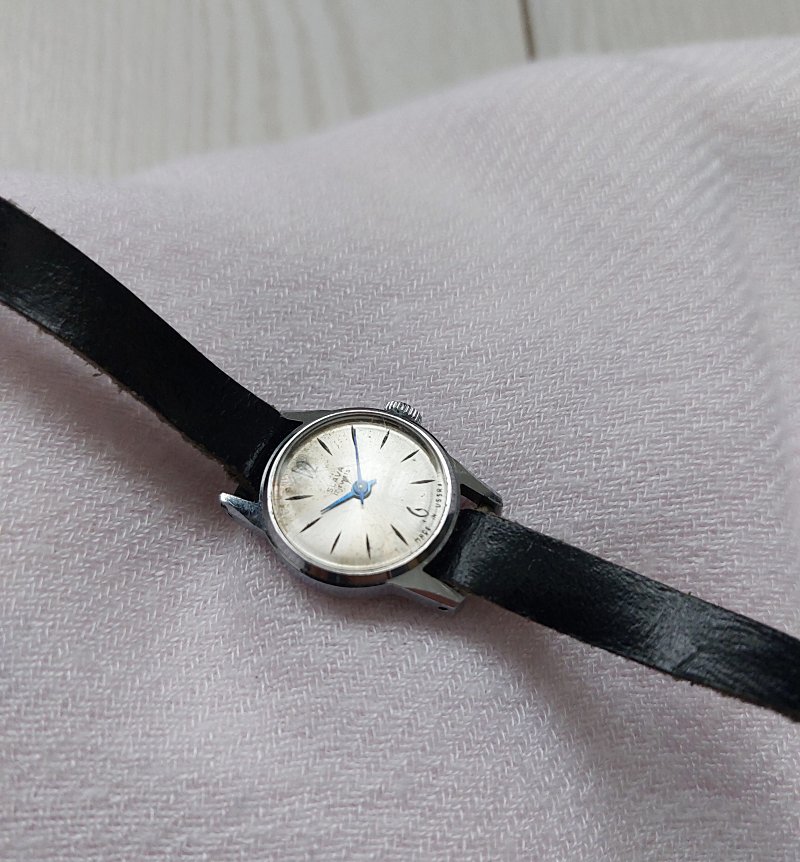 Slava vintage soviet watch with black leather strap.