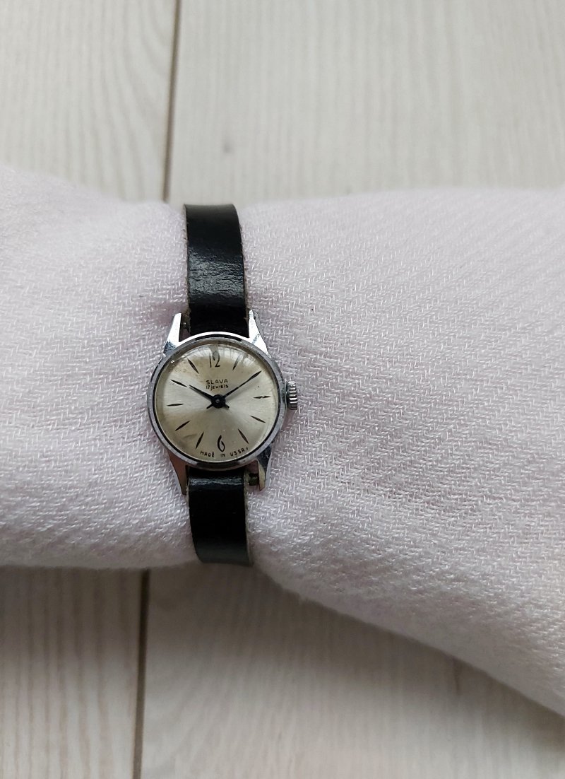 Slava vintage soviet watch with black leather strap.
